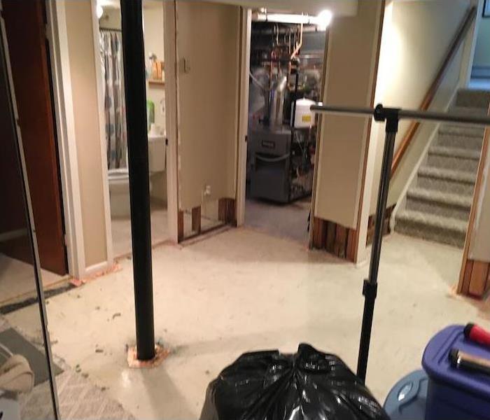 Basement with bare floor and utility equipment 