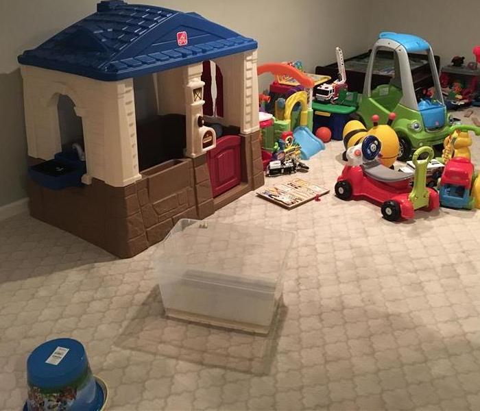 Room with a wet spot on carpet and children’s’ toys
