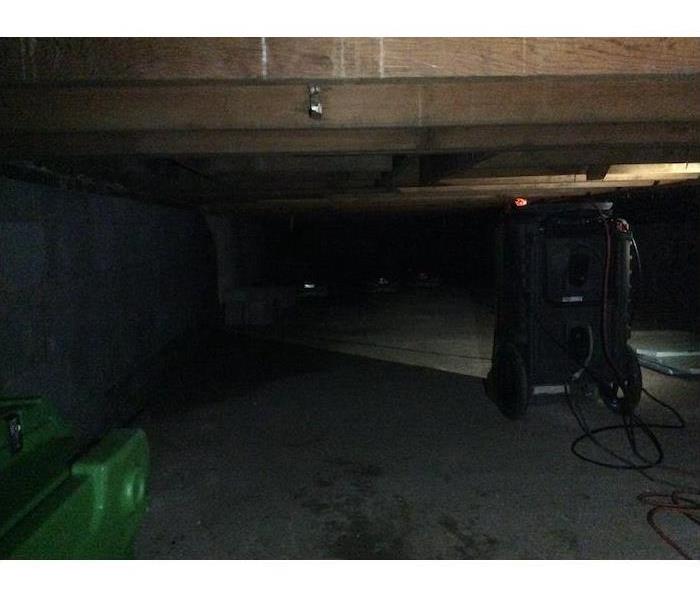 Crawlspace with SERVPRO equipment running