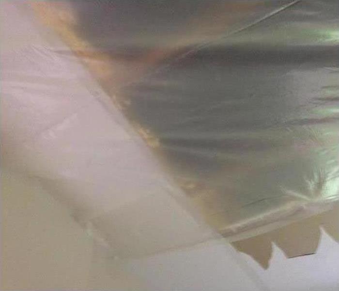 portion of ceiling covered up with a clear covering to allow for direct drying