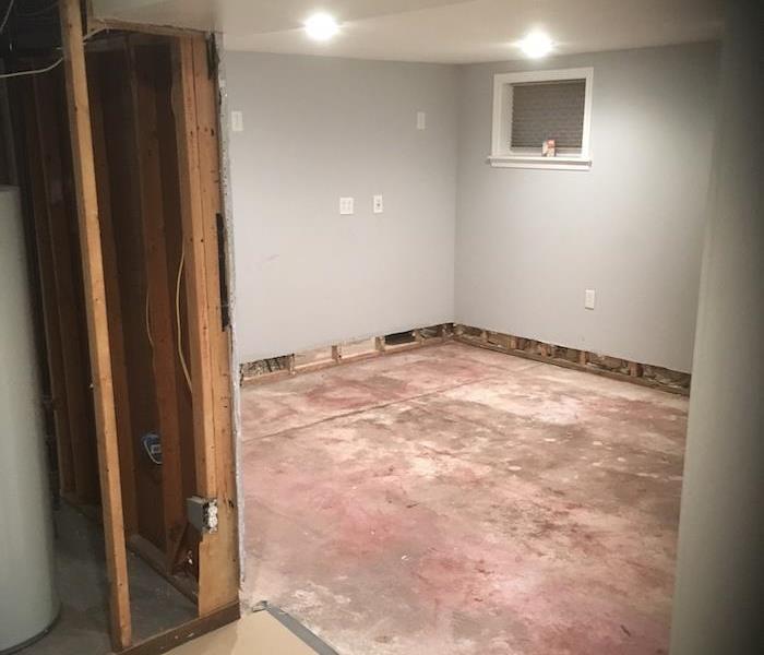 Basement with cut away sheetrock and slab floor