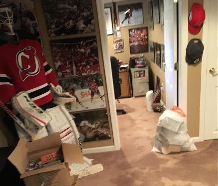 wet carpet, hockey uniform and photos on wall