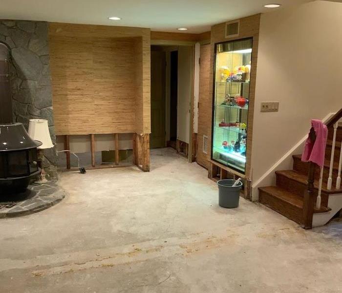 Basement with stairs and concrete slab floor 