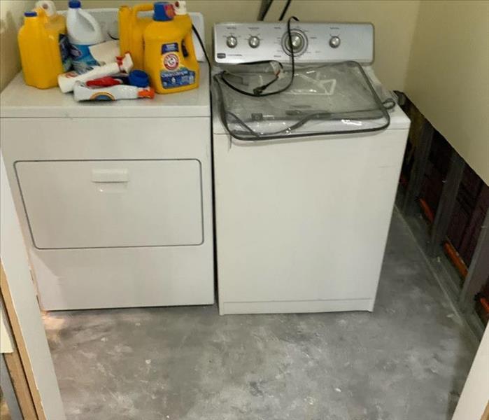 Laundry room with flooring removed and partial removal of the lower wall