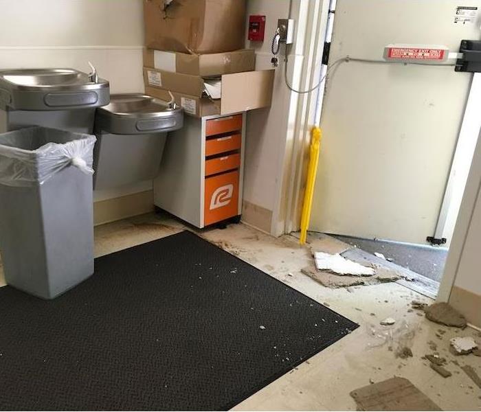 Exit area with sheetrock and debris on the tile floor