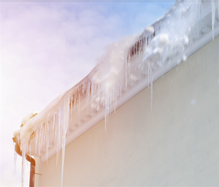 icicles growing on the side of a roof