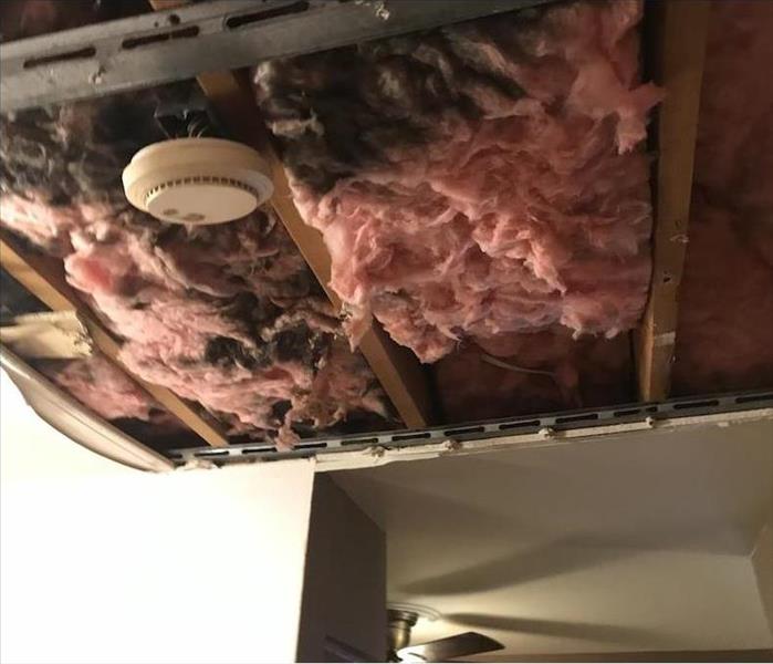 exposed burnt insulation, with removed ceiling drywall