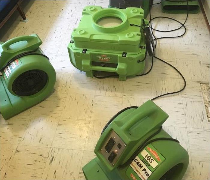 water damage equipment on a linoleum floor