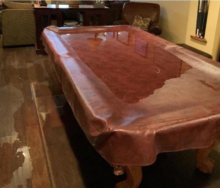 protective covering on pool table; pooling water on covered pool table and floor